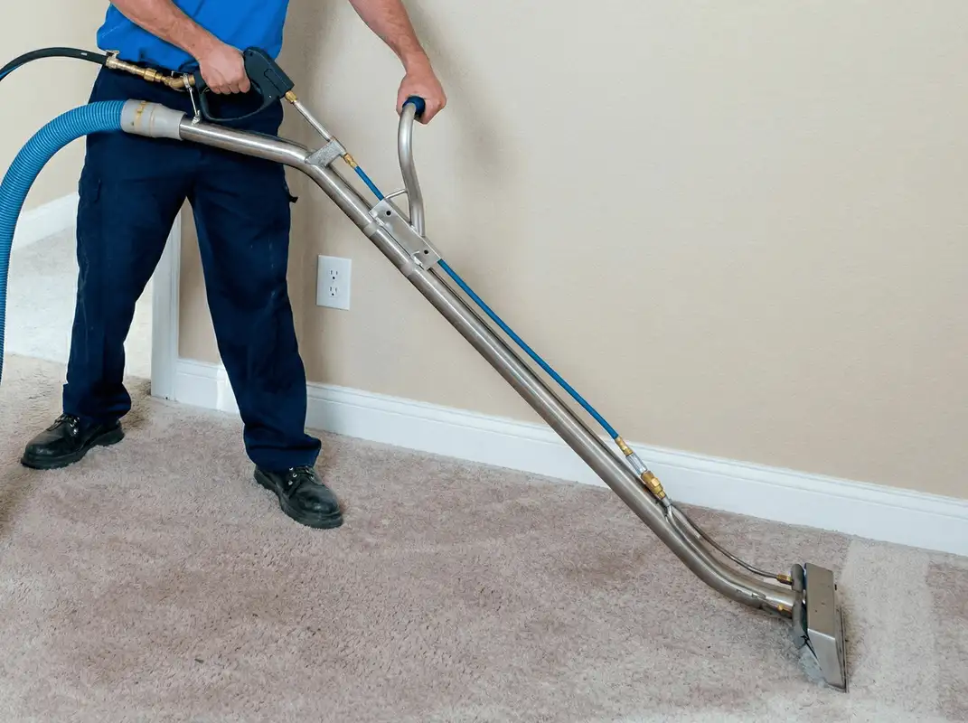 Professional operating a liquid removal machine on a carpeted floor in Fort Wayne, IN